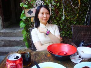 中国上海市内の田子坊という観光地のレストランで、チャイナ服を着てレイレイが座っている写真。